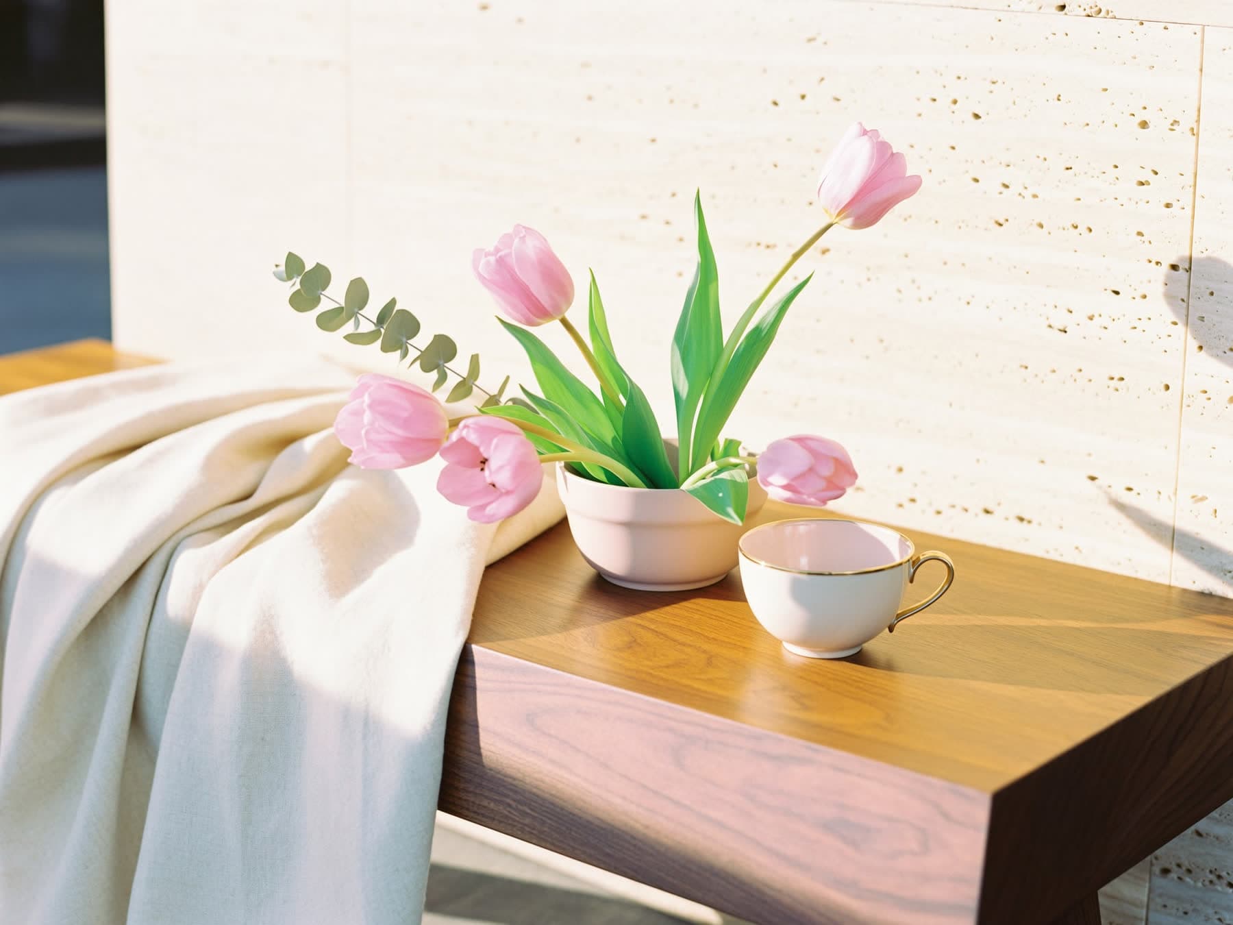 Sunlit still life with pink tulips, eucalyptus, and a teacup, evoking a calm hormone therapy consultation room at Fountain of Youth LC in Las Cruces